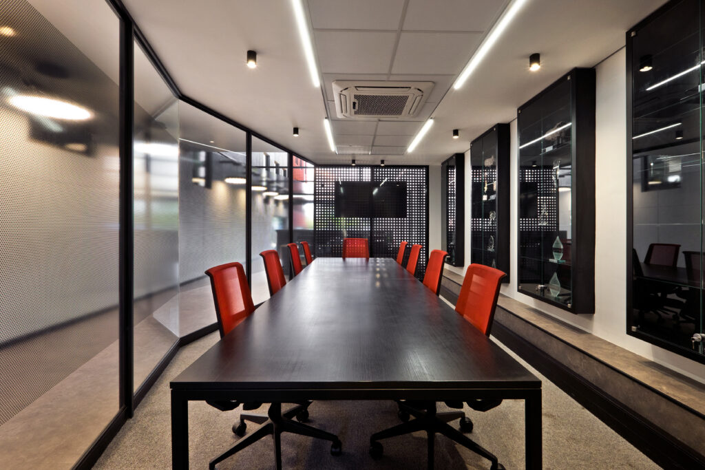 Boardroom with long meeting table and chairs for PMG office