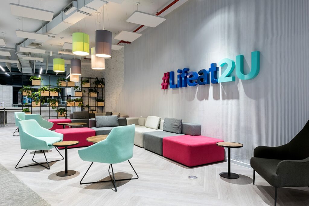 2U modern large commercial building reception area design and construct with 3d type signage and colorful modern and modular soft seating and furniture