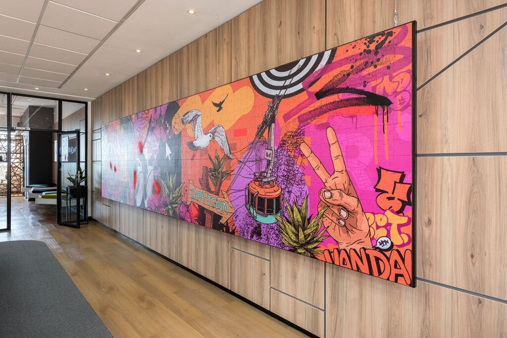Reception wall with colourful artwork for Merchants office in Cape Town