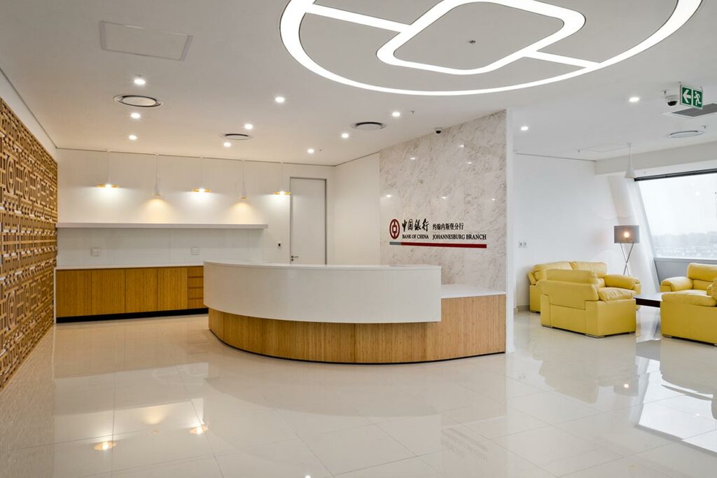 Bank of China office refurbishment project with wooden reception area and yellow seating and custom lighting design