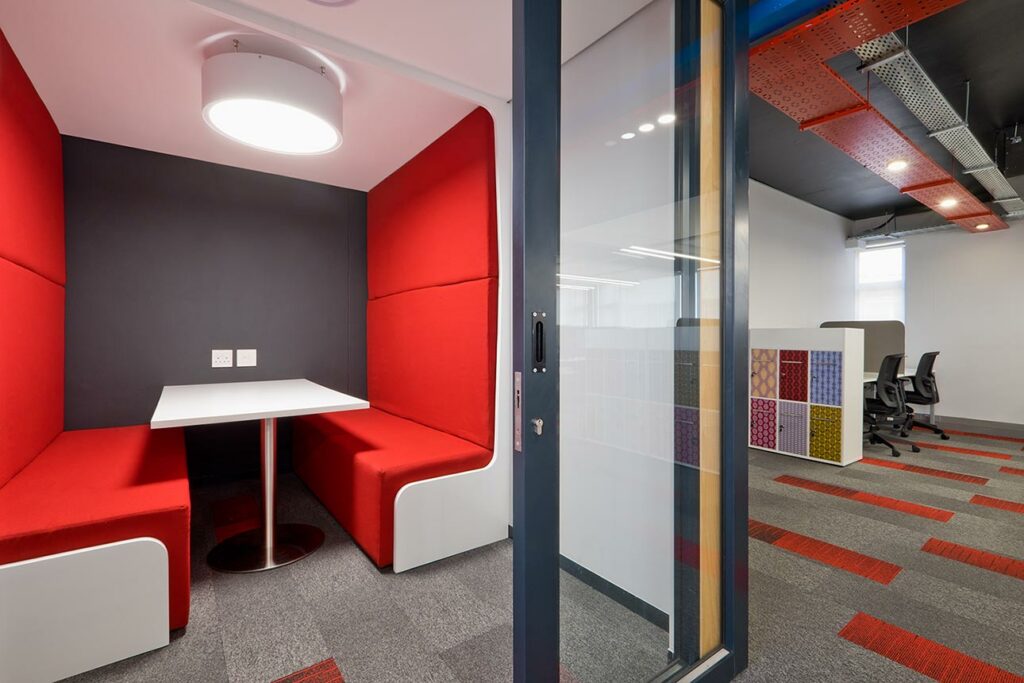 Coca-Cola international modern office with red booth seating interior design