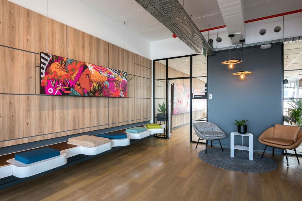 Waiting area with bench seating and wall artwork for Merchants office in Cape Town