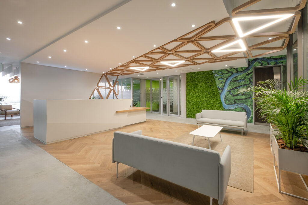 Nokia International office entrance area design with green wall and triangular modern lighting feature