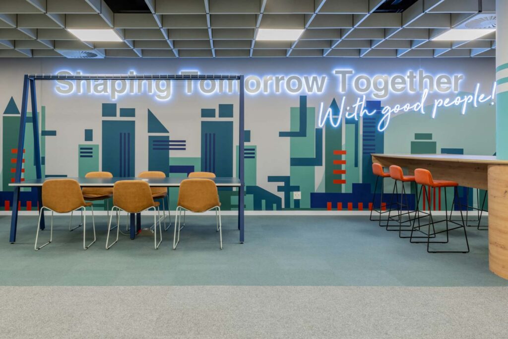 Capita commercial office interiors design and build with colorful meeting area and led lighting for signage