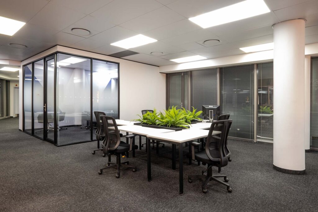 Mazars commercial office with shared desks and plants interior design and fit-out