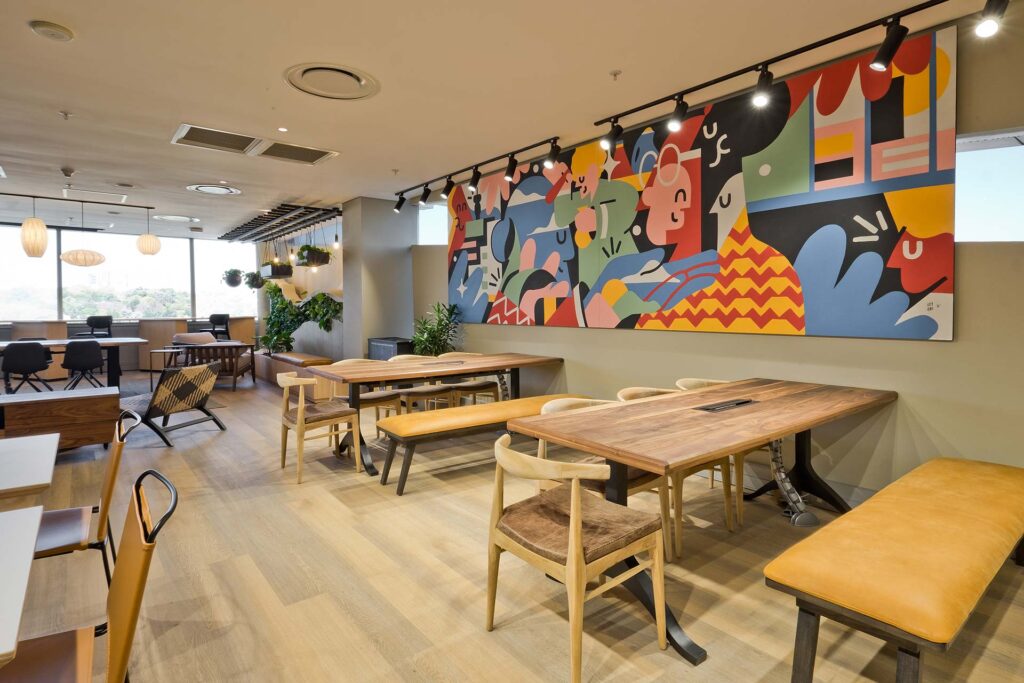 P&G commercial office canteen design with wall art and wooden interior finishes