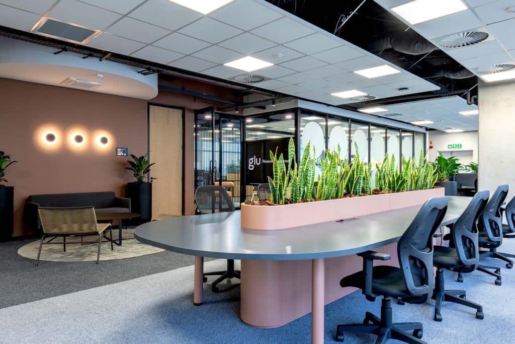 Ergonomic work stations with plant feature by commercial interior designers