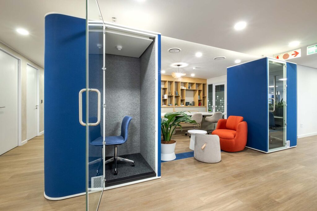Modern commercial office space with acosutic focus booths for productive employees with no distractions