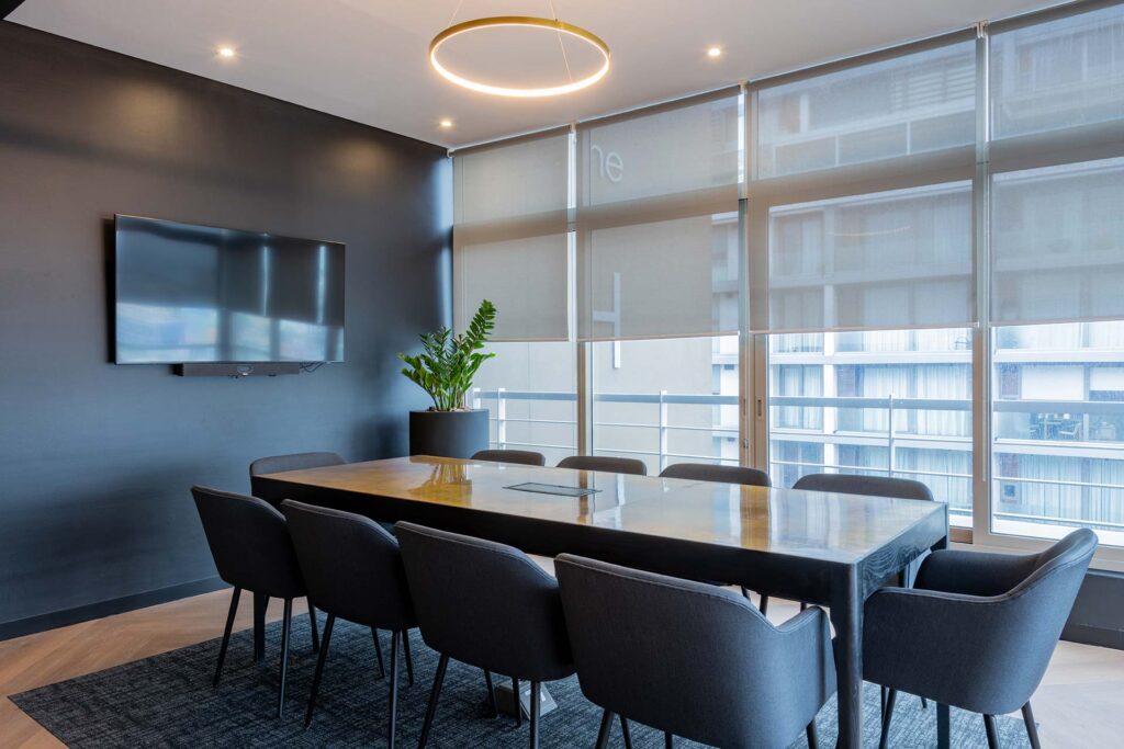 Lionhead Capital luxury office meeting room fit-out with dark wood conference table, leather seating and contemporary interior finishes