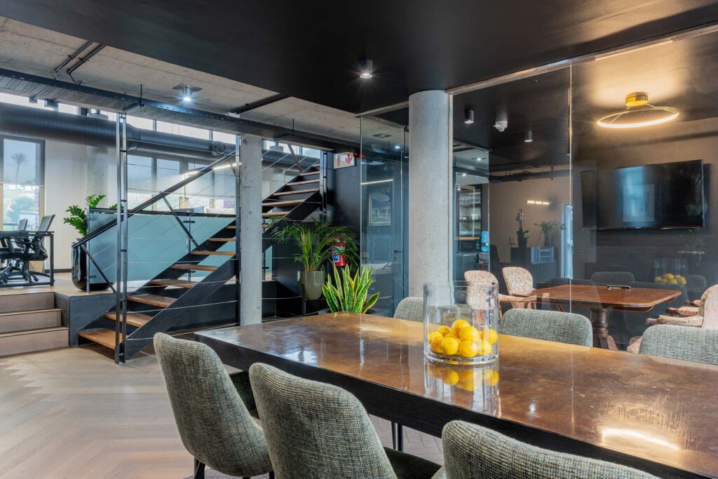 Lionhead Capital modern open plan glass board room with luxury wooden table and high end interior design and furniture